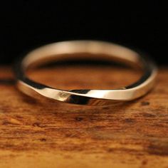 a close up of a wedding ring on a wooden surface