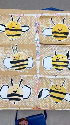 four bees are on brown paper with black and white designs, one is yellow and the other is blue