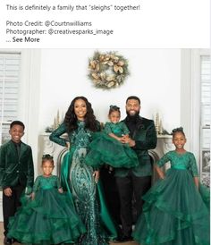 the family is posing for a photo in their green dresses