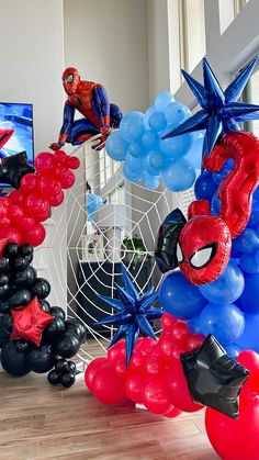 spiderman balloon decorations and balloons in front of a television