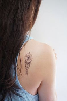 a woman with a tattoo on her back