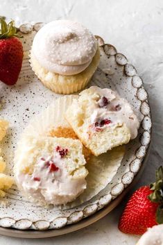 some cupcakes and strawberries on a plate