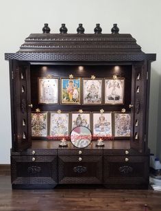 an ornate wooden cabinet with pictures on it