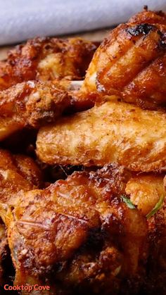 chicken wings are piled on top of each other