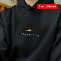 "👑 \"Jesus is King\" embroidered on a comfy hoodie. Everyone needs a cozy go-to hoodie to curl up in, so go for one that's soft, smooth, and stylish. It's the perfect choice for cooler evenings! * 50% pre-shrunk cotton, 50% polyester * Fabric weight: 8.0 oz/yd² (271.25 g/m²) * Air-jet spun yarn with a soft feel and reduced pilling * Double-lined hood with matching drawcord * Quarter-turned body to avoid crease down the middle * 1 × 1 athletic rib-knit cuffs and waistband with spandex * Front po Winter Fleece Hoodie With Embroidered Text, Winter Black Hoodie With Embroidered Text, Winter Hoodie With Custom Embroidery, Custom Embroidered Hoodie For Winter, Fleece Hoodie With Embroidered Text, Custom Embroidered Winter Hoodie, Casual Black Hoodie With Embroidered Text, Christian Apparel Embroidered, Streetwear Hoodie With Embroidered Text