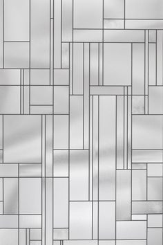 a white and silver tiled wall with lines