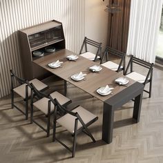 a dining room table and chairs with plates on the placemats next to it