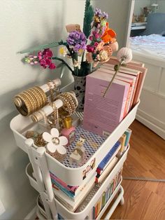 a white cart filled with lots of different types of items on top of a hard wood floor