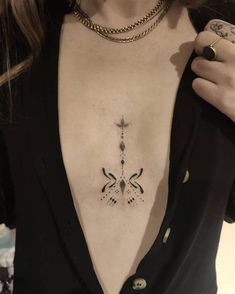 a woman with a cross tattoo on her chest