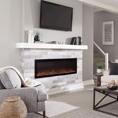 a living room with a fireplace and television on the wall, in front of a flat screen tv