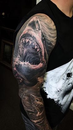 a man with a shark tattoo on his arm