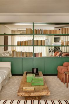 a living room filled with furniture and bookshelves full of bookcase's