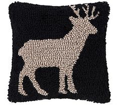 a black pillow with a white deer on it