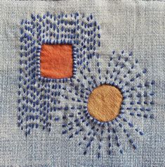 a close up of a piece of cloth with stitching on it and two squares