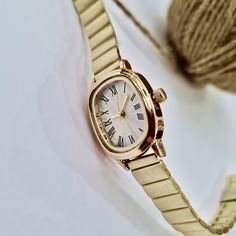 Wrist Watch for Women, Present for Her, Gold Colour, Vintage Design, Adjustable Band, White Dial, Valentine's Day Gift, Cool Design, Roman Numeral - All Stainless Steel band (Gold Colour) - Easy usable and durable - Reaches with a gift box - Can be ordered with a message or empty - Dimensions of Watch:        Total Lenght of Watch: 22,5 cm        Case Diameter: 25,5 x 21,5 mm        Case Thickness: 8 mm        Weight: 40 gr If you indicate your wrist thickness at personalization side, we will send the watch after adjusting it. Elegant Gold Watch For Gift, Small Women Gold Watches, Tiny Gold Watch, Gold Watches For Valentine's Day, Dainty Gold Watch Vintage, Vintage Gold Watch, Simple Watches, Gold Watches Women, Gold Watch Men