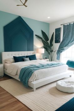 a bedroom with blue walls and white bedding in the center, along with a rug on the floor