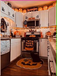 a kitchen decorated for halloween with pumpkins and decorations