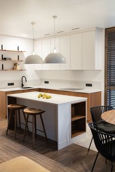 a kitchen with an island and two stools