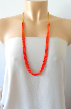 "Delicate and dainty long beaded orange necklace. It measures 30\". ❤ SHIPPING Please check shipping options and timeframe once you add item/s to the cart. In addition, you can click on the tab \"Shipping & Policies\" above for more information on processing time and cost. ❤ CUSTOM ORDERS If you like this item in a different color, send me a message indicating: color, size and quantity needed. I will send you a link for a \"custom order\" and you'll be able to place the order there. If you l Bohemian Orange Necklace For Wedding, Handmade Orange Beaded Necklace For Wedding, Handmade Multi-strand Orange Beaded Necklaces, Orange Multi-strand Colorful Beads Jewelry, Orange Multi-strand Beaded Necklaces, Orange Multi-strand Beaded Necklace, Orange Multi-strand Beads As Gift, Long Orange Beaded Necklaces, Beaded Orange