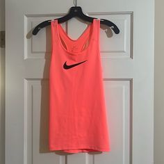 Gorgeous Tank Top With Racer Back And Nike Logo In Front For All Those Nike Lovers. :) Pretty Neon Color. Brand New, Never Worn And In Perfect Condition. Dry Fit Fabric Pink Gym Tops For Spring, Nike Pink Tops For Gym, Nike Pink Gym Tops, Nike Casual Pink Tank Top, Nike Sporty Pink Tank Top, Casual Nike Pink Tank Top, Casual Pink Nike Tank Top, Nike Pink Tops For Summer, Nike Pink Summer Tops