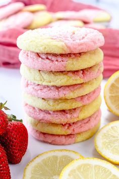 a stack of lemon and strawberry shortbread cookies next to sliced strawberries