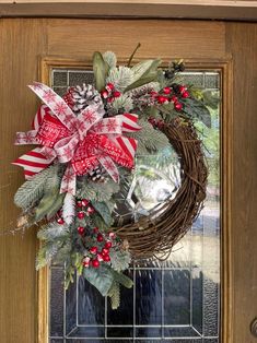 a christmas wreath is hanging on the front door