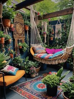 a hammock hanging in the middle of a room filled with potted plants