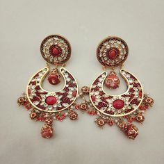 Enhance your look with these elegant Coral Chandbali Earrings. Featuring intricate designs with coral drops, these earrings bring a perfect blend of tradition and sophistication to any outfit. Ideal for festive occasions, they add a vibrant and graceful touch to your ensemble. Length: 3" to 3.5" Material: 24Kt gold foil, lac Stones: Kundans, semi precious corals, semi precious pearls Chandbali Earrings, Coral Flowers, Pin Pendant, 24kt Gold, Pendant Rings, Intricate Designs, Natural Beads, Gold Foil, Necklaces Bracelets