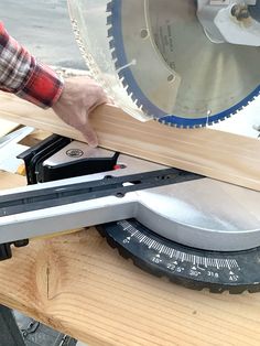 a person using a circular saw to cut wood