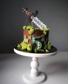 a cake that is sitting on top of a white plate with green grass and letters