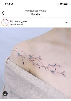 a small tattoo with blue flowers on the chest