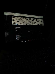 a laptop computer lit up in the dark