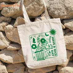 💟 The tote bag for Nature lovers. 💟 The perfect gift for friend, for mom, for sister, or anyone else. ------------------------------------------------------------------------------------------------- ABOUT OUR TOTES ◆ Dimensions: 15 x 15 inches ◆ Material: 100% cotton canvas, with heavy-duty woven handles. ◆ Bag volume capacity, approx. 12 liters. ◆ Strap handles measure 30 inches. ◆ Strap drop (high point of strap to bag opening) measures 11 inches. ◆ Imprint on one side. ◆ Handles feature st Earth Day Tote Bag, Eco-friendly Green Grocery Bags, Green Canvas Bag With Eco-friendly Ink As Gift, Green Tote Bag With Eco-friendly Ink, Green Recyclable Bags For Gifts, Tote Bag Graphic Design, Cute Tote Bag Design, Tote Bag Designs, Graphic Tote Bag