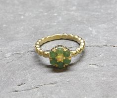 Gold Flower Ring set with Natural Emerald in smooth grade & natural green color, from Colombia, at 3mm each, with small Ethiopian Opal (centre stone), 1 Carat ring. Green Daisy Ring in Vintage inspired style made of Gold Vermeil ☞ thickest 18k Gold Plating on top of Solid 925 Sterling Silver ☞ made to last. Matching Earrings: www.etsy.com/uk/listing/868568007 Matching Pendant - please ask me May & October Birthstone - Genuine & Natural Stone ❀ ⌛Last Ring left ⌛ ☞ Choose your size ☞ I resize (bef Green Daisy, Natural Emerald Rings, Gold Flower Ring, Emerald Ring Gold, Daisy Ring, Jewelry Design Inspiration, Ring Opal, May Birthstone, October Birthstone