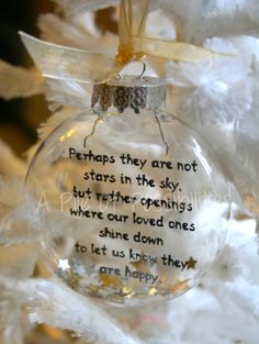 a glass ornament with a poem on it sitting on top of a tree