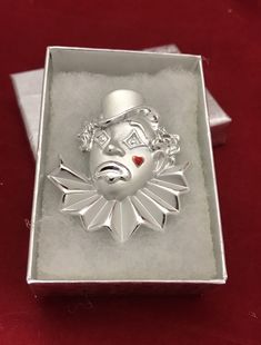 "This is a very nice silvertone ( both shiny and matte ) clown brooch. It is signed AJC and measures 2\" x 1 3/4\". The clown looks very sad and has a red enameled, heart shaped tear on his face. He is in excellent condition and will arrive in a pretty silver gift box with free domestic shipping. This would make a great addition to a clown collection. Money from the sale of Angelic Beaders jewelry goes to support the ministries and programs of Rocky Cross Baptist Church. www.rockycross.org" Silver Novelty Brooches For Gifts, Clown Looks, Clown Collection, Pewter Jewelry, Dollar Gift, Silver Gift Box, A Clown, Porcelain Roses, The Clown