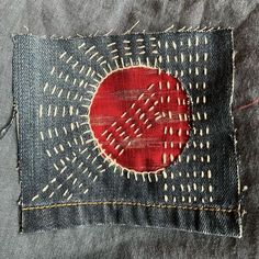 a piece of cloth with an image of a red circle in the center on it