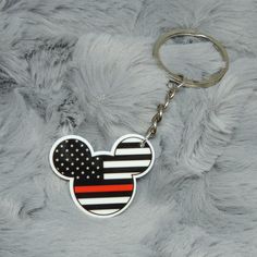 a mickey mouse keychain with the american flag on it's back side