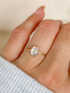 This gorgeous Rainbow Moonstone Ring is the focus of this handmade ring. It’s a Unique rainbow color in a beautiful natural stone. This beautiful moonstone ring is a gift or gift for yourself, it will illuminate your best qualities and bring forth creativity and inspiration. Details:• 14K gold filled & sterling silver• band: hammered style• gemstone: Genuine Rainbow Moonstone• measures stone: 6mm x 8mmmeasure band: approx 1.0mm - 1.5mm shape: oval............................................***Mo Simple Moonstone Ring, Moonstone Jewelry Rings, Silver Crystal Ring, Moonstone Silver Ring, Silver Stone Rings Women, Opal Moonstone Open Ring For Gift, Moonstone Gold Ring, Handmade Moonstone Opal Ring For Promise, Minimalist Moonstone Ring With Natural Stones As Gift