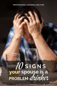 a man sitting at a table with his hands on his head and two glasses in front of him