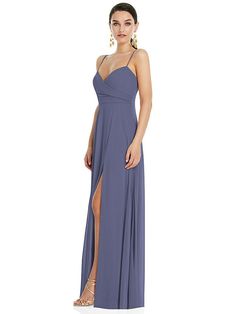 a woman in a long blue dress with a slit down the side and one leg