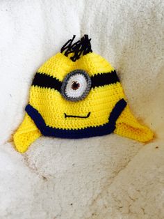 a crocheted yellow and black hat with eyes