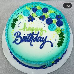 a birthday cake with blue flowers and the words happy birthday written in frosting on it