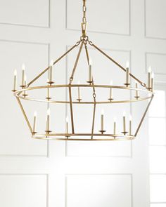 a chandelier hanging from the ceiling in a room with white paneled walls