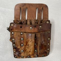 an old leather comb holder with metal rivets