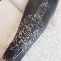 a black and white tattoo on the leg of a person