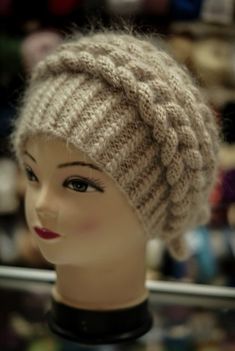 a mannequin head wearing a knitted hat