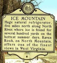 a sign in front of a tree that says ice mountain, huge natural refrigerator five miles north along north river where it is found for several hundred yards on the