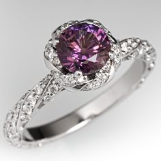 a purple diamond ring with white diamonds around it