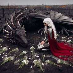 a woman sitting on the ground next to a dragon